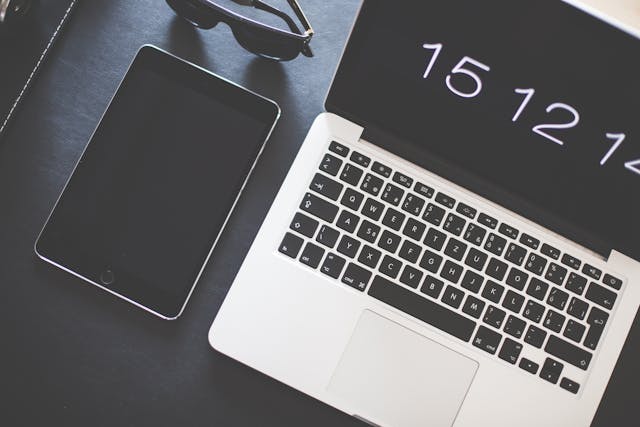 A laptop and a smartphone side by side, showing a responsive website design